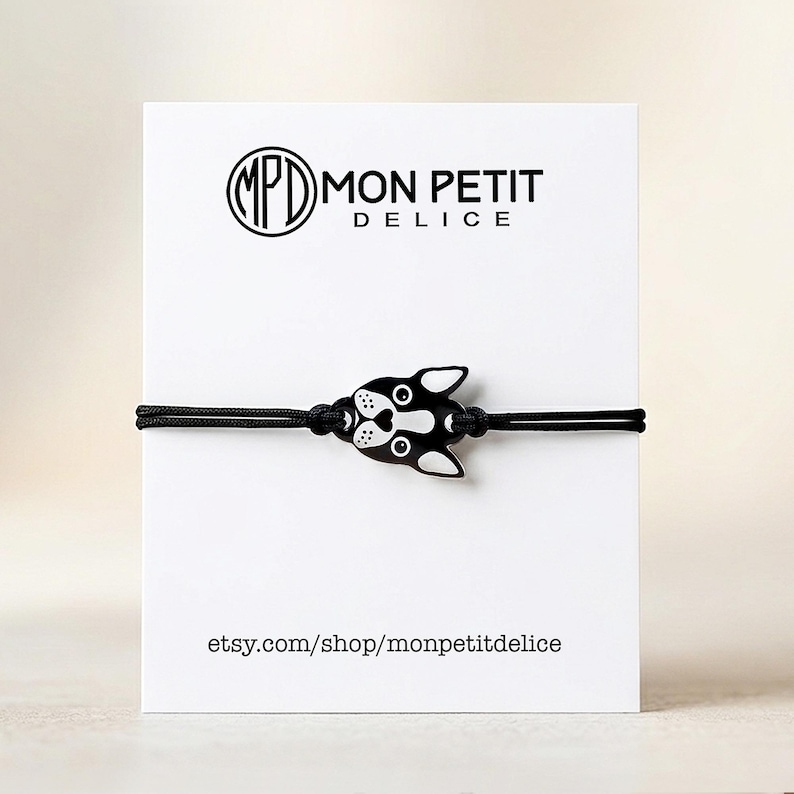 Boston Terrier bracelet displayed on a white Mon Petit Delice backing card. Ready to gift packaging for dog birthdays or pet memorial gifts.
