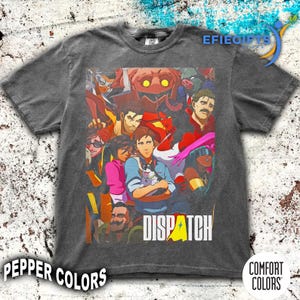 May include: Dark grey t-shirt with a vibrant graphic of cartoon characters. The word "DISPATCH" is printed in white with a yellow accent. The shirt is from the "Pepper Colors" and "Comfort Colors" brands.