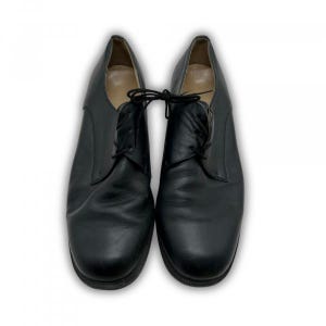 May include: A pair of black leather dress shoes with laces. The shoes have a classic design with a rounded toe and a low heel. The shoes are displayed on a white background.