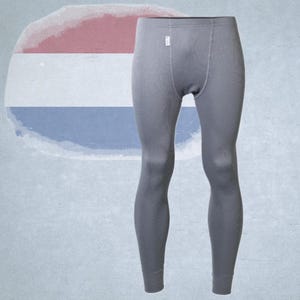 Könnte beinhalten: Graue Thermounterhose mit gerippter Struktur. Die lange Unterhose hat ein kleines Etikett in der Nähe der Taille. Der Hintergrund zeigt eine verblasste niederländische Flagge. Für Wärme konzipiert.