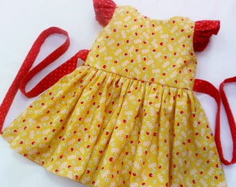 Apple Dress for Baby Girl, sizes 0-3m, 3-6m, 6-12m, and 12-18m, flutter sleeves, attached sash, yellow with red apples and flowers