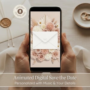 Może przedstawiać: Smartfon wyświetla cyfrowy projekt save-the-date z kompozycją kwiatową z białych i różowych róż. Na ekranie znajduje się koperta z inicjałami "VIC". Obraz zawiera zaproszenie ślubne, obrączki i tekst.