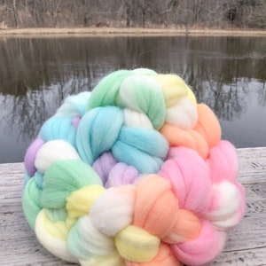 4 ounces merino combed top, wool roving, perfect for spinning or felting, hand dyed in a pastel and cream rainbow