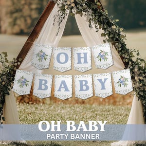 May include: A banner with the words "OH BABY" in light blue letters. The banner is made of white pennants with a floral design and blueberry illustrations. The banner is displayed outdoors, with a wooden arch and greenery in the background.