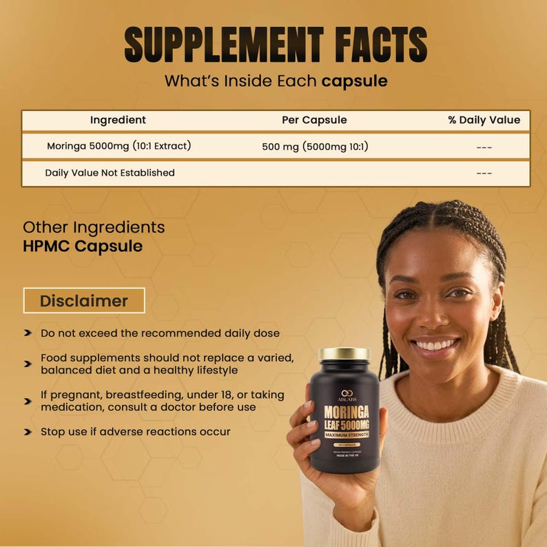 May include: A black supplement bottle with a gold lid is held by a smiling person. The bottle has a label that reads "MORINGA LEAF 5000MG MAXIMUM STRENGTH". The background includes text about supplement facts and ingredients.