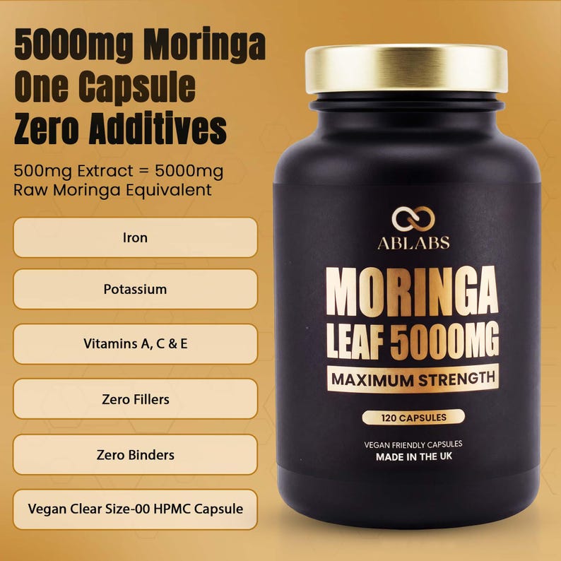 May include: A black supplement bottle with a gold cap and white text. The label reads "MORINGA LEAF 5000MG MAXIMUM STRENGTH" and lists "120 CAPSULES". Additional text highlights the product's features, including "Zero Additives" and "Vegan Friendly Capsules".