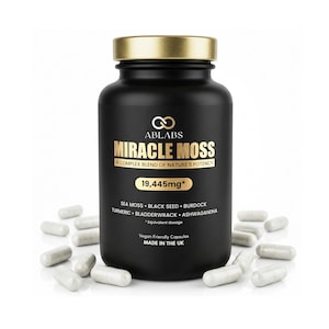 May include: A black supplement bottle with a gold cap and the text "MIRACLE MOSS" in gold lettering. The bottle is surrounded by several white capsules. The label includes the text "A COMPLEX BLEND OF NATURE'S POTENCY" and "19,445mg*."