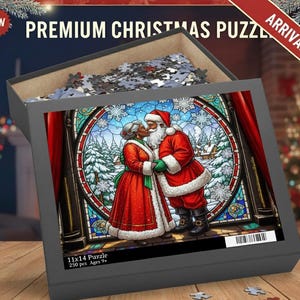 May include: A premium Christmas puzzle in a gray box. The puzzle image features Santa Claus and Mrs. Claus kissing in front of a stained-glass window with a winter scene. The box reads "Premium Christmas Puzzle" and "Arrival!" The puzzle is 11x14 inches.