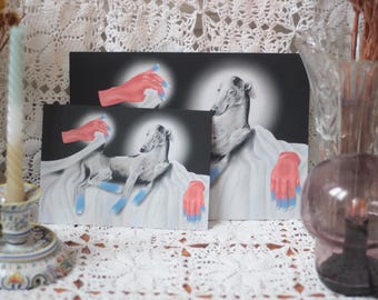 May include: Artwork depicting a greyhound with red hands and blue nails. The artwork is displayed on a white surface, with a black background. The image is a painting or print, with a surreal and artistic style.
