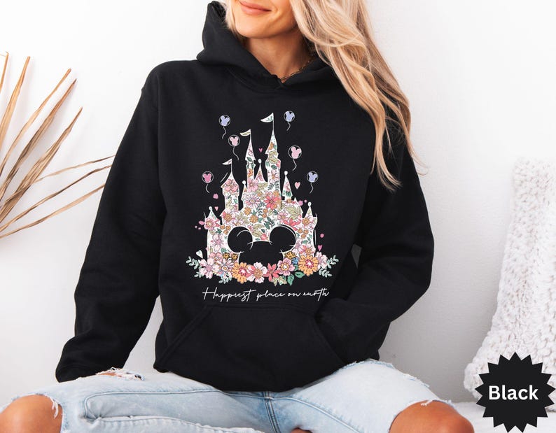 May include: Black hoodie with a floral design of a castle and the text "Happiest place on earth".