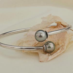 Melanie - Pearl Bangle Bracelet Features Tahitian Pearls Set in a Solid, Rhodium Plated Sterling Silver Flex design.