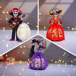 May include: Three Día de Muertos-themed paper lanterns. One features a skeleton mariachi playing a guitar, another a skeleton in a red dress, and the third a skeleton couple. The lanterns are lit from within, casting a warm glow.