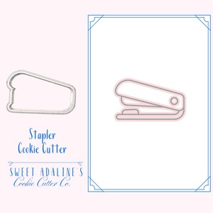May include: A light pink and grey stapler cookie cutter and a stapler illustration on a light pink background. The text "Stapler Cookie Cutter" and "Sweet Adaline's Cookie Cutter Co." are below the cookie cutter.