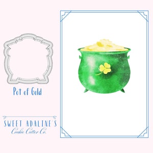 Peut inclure: Un emporte-pièce en forme de pot d'or. L'emporte-pièce est argenté et présente un design détaillé. L'image montre également une illustration aquarelle d'un pot d'or vert avec un trèfle à trois feuilles sur le côté.