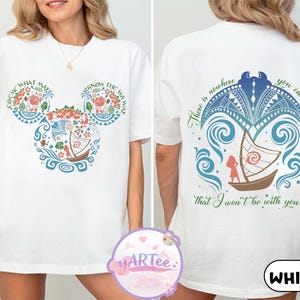 May include: White t-shirt featuring a colorful design of a boat and floral elements in the shape of Mickey Mouse ears on the front. The back of the shirt has a boat design with the text "There is nowhere you can go that I won't be with you..."