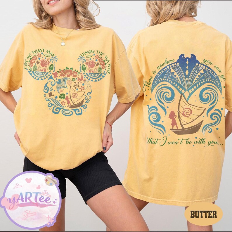 May include: Yellow t-shirt with a front graphic featuring a Mickey Mouse head design with floral and boat motifs, and text that reads "COME WHAT MAY" and "KNOW THE WAY." The back of the shirt has a boat design and the text "There is nowhere you can go that I won't be with you..."
