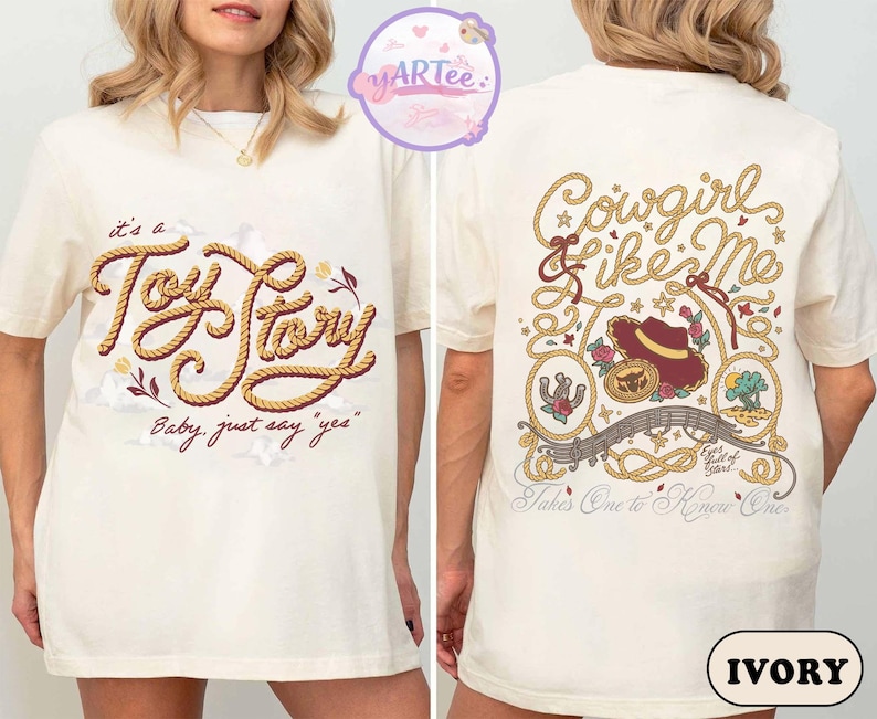 May include: An ivory t-shirt featuring a front graphic with the text "it's a Toy Story" in a rope-style font and "Baby, just say "yes"" below. The back graphic displays "Cowgirl Like Me" with a cowboy hat, lasso, and desert imagery.