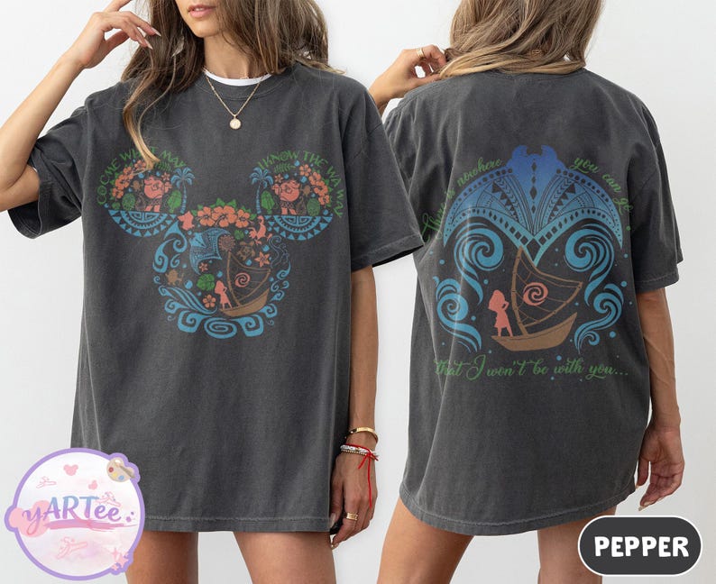 May include: Dark gray t-shirt with a colorful graphic on the front and back. The front features a Mickey Mouse-shaped design with floral and boat motifs, and text. The back has a boat design and text. The shirt is a casual wear item.