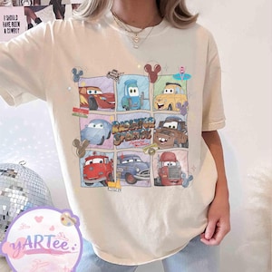 May include: Cream-colored t-shirt featuring a grid of cartoon cars from the movie Cars. The grid includes Lightning McQueen and Mater, with the text "Radiator Springs" and "Lightning McQueen".