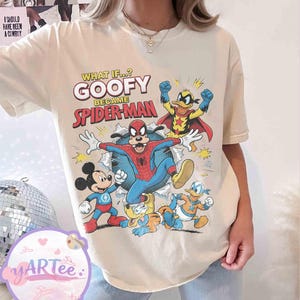 May include: Cream-coloured t-shirt with a graphic of Goofy as Spider-Man, alongside Mickey Mouse, Donald Duck, and Pluto. The text reads "WHAT IF...? GOOFY BECAME SPIDER-MAN". The shirt has a vintage, distressed appearance.