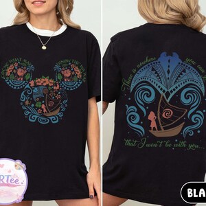 May include: Black t-shirt with a white collar featuring a colorful graphic of a boat and floral design in the shape of Mickey Mouse ears. The back of the shirt has a matching design with text that reads "There is nowhere you can go that I won't be with you..."