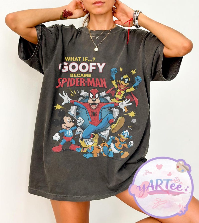 May include: Dark grey t-shirt with a graphic of Goofy as Spider-Man and other cartoon characters. Text reads "WHAT IF...? GOOFY BECAME SPIDER-MAN". The shirt has a vintage, distressed appearance.