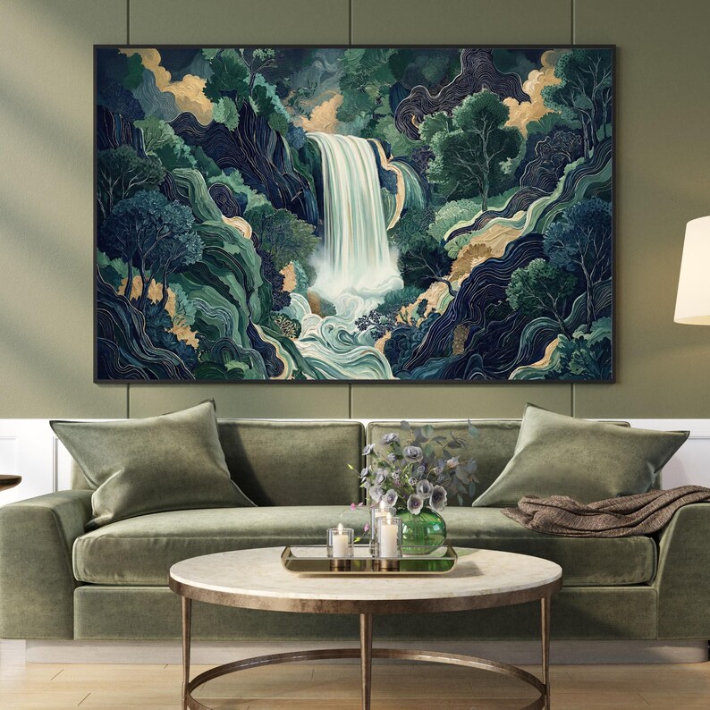 Vertical Japanese waterfall wall art print hanging above a sage green sofa in a modern living room, featuring a cascading white waterfall through deep navy canyon walls and emerald foliage, styled with a round coffee table and neutral decor.