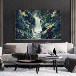 Large framed Japanese waterfall wall art displayed above a modern beige sofa, featuring a dramatic vertical white waterfall flowing through deep navy canyon cliffs and emerald green foliage, styled in a contemporary living room with dark paneled walls and a minimalist coffee table.