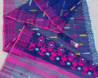 May include: A navy blue and gray saree with pink and yellow accents. The saree features intricate geometric and floral patterns, with a matching fabric piece and a small, rolled accessory. The design includes stripes and dotted details.