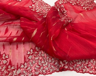 May include: Red sheer fabric with gold thread embroidery and a silver floral design along the edge.