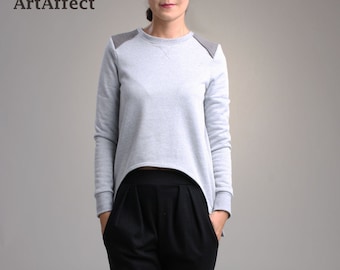 Blusa de manga comprida com recorte: detalhe de remendo no ombro