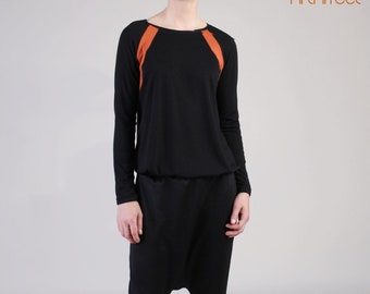 Blusa com estampa de blocos de cores e manga raglan: manga comprida preta e laranja