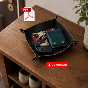 May include: A black leather valet tray with metal corner fasteners containing a dark green leather wallet, a set of silver keys, and a black car key fob. The tray sits on a wooden surface. The image includes a PDF icon and a red DOWNLOAD button.