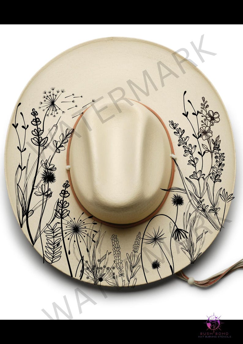 May include: A beige straw hat with a black floral design. The hat has a brown leather band and a black tassel.