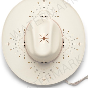 May include: A white cowboy hat with a brown band and gold and black starburst designs.