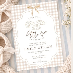 May include: A baby shower invitation with a beige and white gingham background. The invitation features the text "There's a Little Bun in the Oven" with illustrations of baked goods. Details include the name Emily Wilson, date, time, and RSVP information.