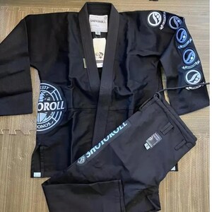 May include: Black and blue Jiu-Jitsu gi with a world logo and the text "Shoyorroll" on the jacket. The pants have the text "Shoyorroll" on the side.