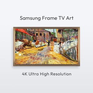 以下が含まれることがあります： Samsung Frame TV用の額入りデジタルアート。画像は、建物、人物、樽のある賑やかな屋外シーンを描いた鮮やかな絵画です。「Samsung Frame TV Art」と「4K Ultra High Resolution」の文字が表示されています。