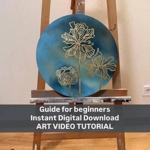 Puede incluir: Una pintura circular con tres ilustraciones florales de líneas doradas sobre un fondo degradado en azul y verde azulado, sobre un caballete de madera. El texto dice: Guide for beginners, Instant Digital Download, ART VIDEO TUTORIAL.