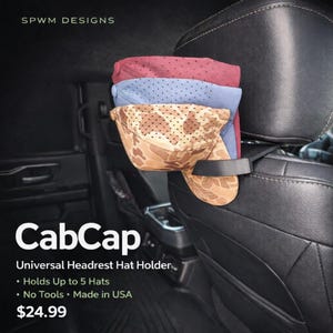 May include: Black CabCap universal headrest hat holder with three hats in red, blue, and camouflage patterns. The holder attaches to a car seat headrest and can hold up to 5 hats. The text on the image says "CabCap" and "Universal Headrest Hat Holder."