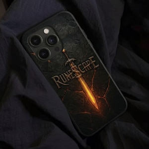 May include: Black phone case featuring the word "Runescape" and a glowing sword design. The case has a textured, cracked earth background. The sword is golden with a bright, fiery glow. The case is designed for a smartphone.