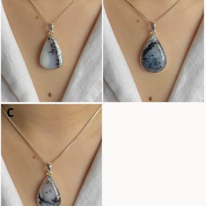 May include: Three teardrop-shaped pendants labeled A, B, and C, each featuring a white stone with black dendritic inclusions. The stones are set in silver-toned metal frames and suspended from thin silver-toned chains worn around the neck.