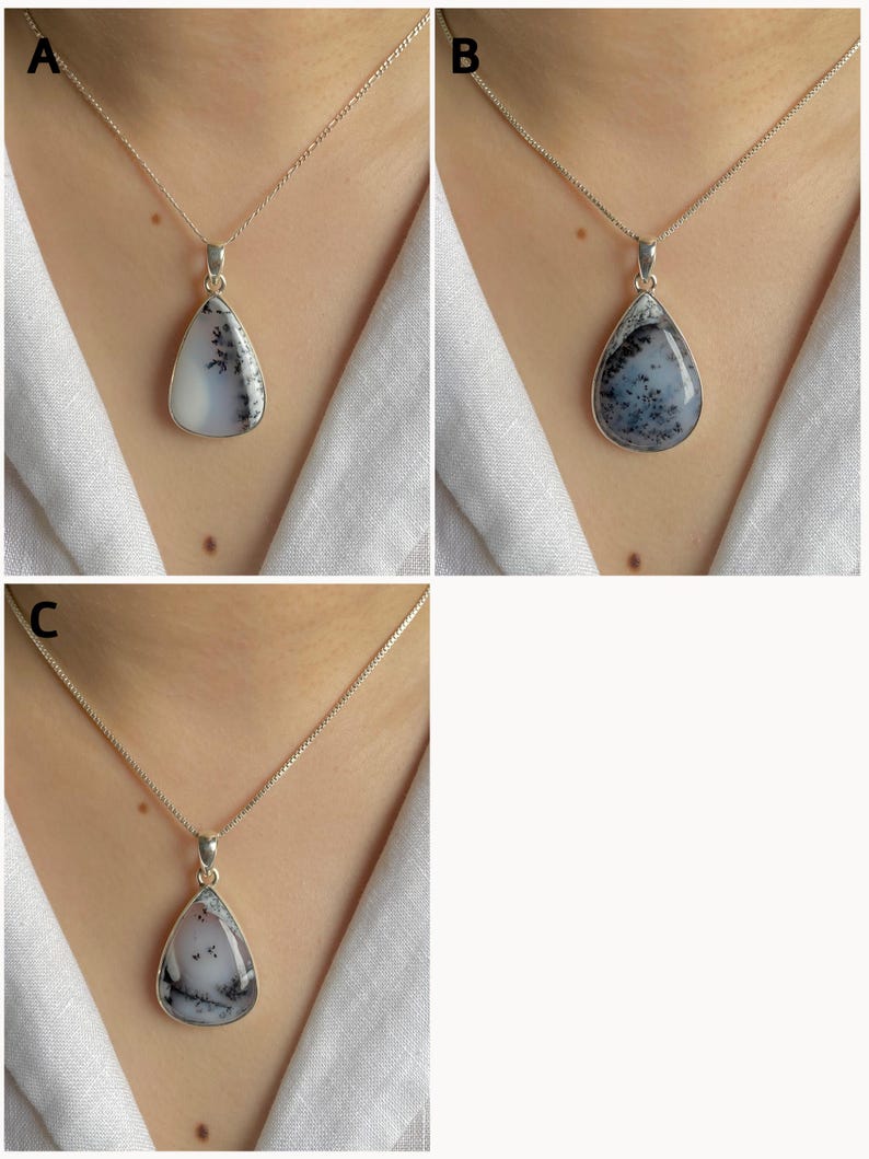 May include: Three teardrop-shaped pendants labeled A, B, and C, each featuring a white stone with black dendritic inclusions. The stones are set in silver-toned metal frames and suspended from thin silver-toned chains worn around the neck.