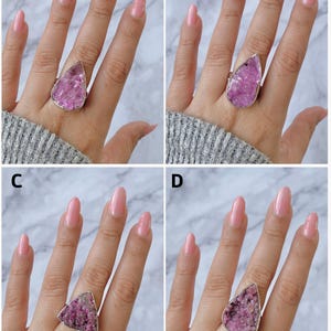 May include: Four images showcasing rings with large, irregular, pink gemstones set in silver-colored metal. The gemstones have a textured, crystalline appearance. The rings are displayed on a hand with pink nail polish, against a gray sweater.