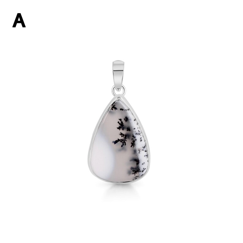 May include: A teardrop-shaped pendant featuring a smooth, translucent white stone with dark, branching dendritic inclusions. The stone is encased in a polished silver-toned metal setting with a small, integrated bail at the top for suspension.