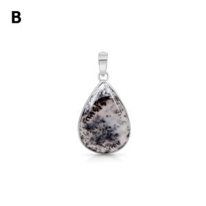 May include: A teardrop-shaped pendant featuring a white stone with black dendritic fern-like inclusions, encased in a polished silver-toned metal setting with a matching silver-toned bail at the top. The letter B is visible in the upper left corner.