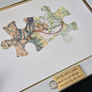 May include: A white ceramic mug with a black handle and the text "But First, Coffee" in a black, bold font. The mug is on a white surface. The mug is approximately 4 inches tall.