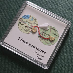 May include: A set of three ceramic mugs with a speckled, matte finish in cream, light grey, and dark grey. Each mug has a simple, minimalist design, suitable for coffee or tea.