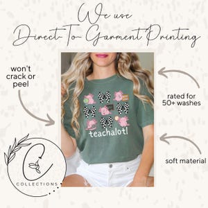 May include: An olive green t-shirt with a design of pink axolotls, checkered bows, and the word "teachalotl." The shirt has the text "We use Direct To Garment Printing" at the top. The shirt is rated for 50+ washes and made of soft material.