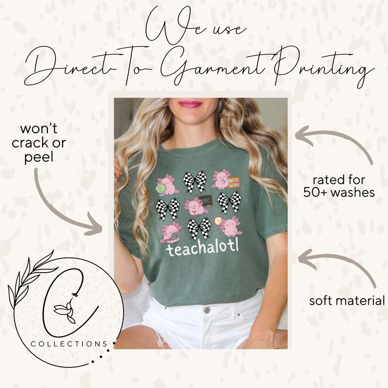 May include: An olive green t-shirt with a design of pink axolotls, checkered bows, and the word "teachalotl." The shirt has the text "We use Direct To Garment Printing" at the top. The shirt is rated for 50+ washes and made of soft material.